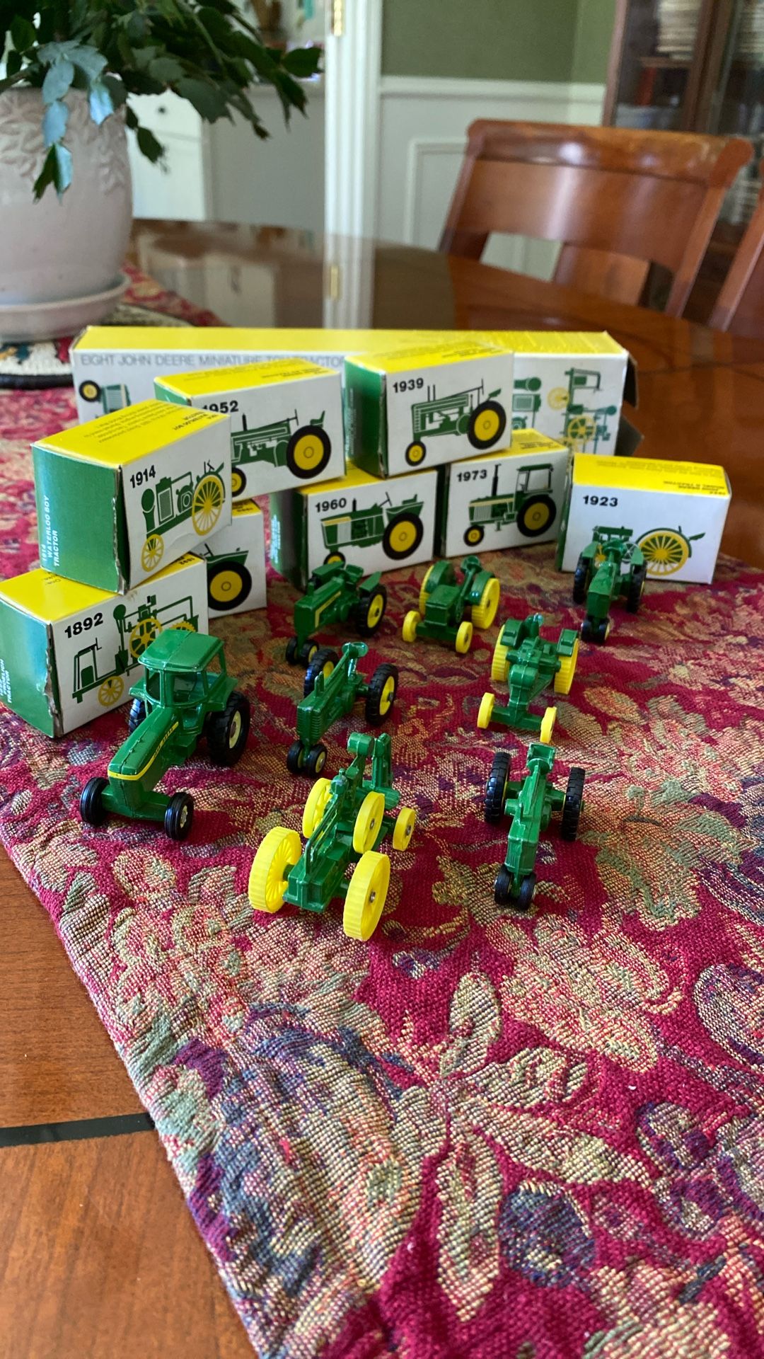 Eight John Deere Miniature Die Cast Tractors