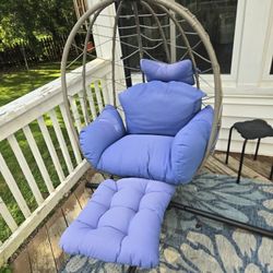 hanging egg chair with a stand and a detachable footrest. 