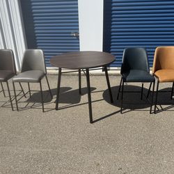 Jofran  Five Piece Round Modern Solid Wood Counter Height Dining Set. Mis Matched Color Faux Leather Stools. Table  42” wide  42” deep  36” tall  Stoo