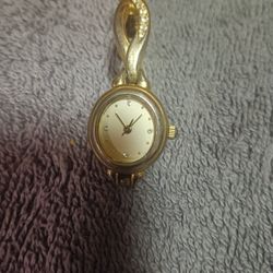 Gold Toned Ladies Wrist Watch ⌚ Features A White Dial With Crystal Hour Markers And A Twisted EMBELLISHED Band For Sale.