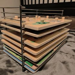 Eight wooden puzzles with a rack for storage.