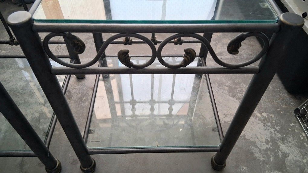 Set of 2 Matching Wrought Iron End Tables / NightstandsBeautiful matching set of 2 wrought iron tables featuring a clear glass top and a glass bottom