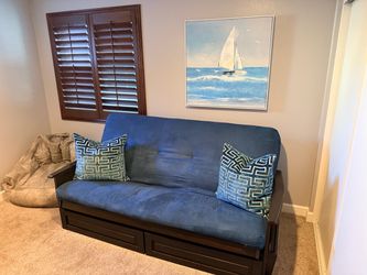 Futon with storage drawers and shelves