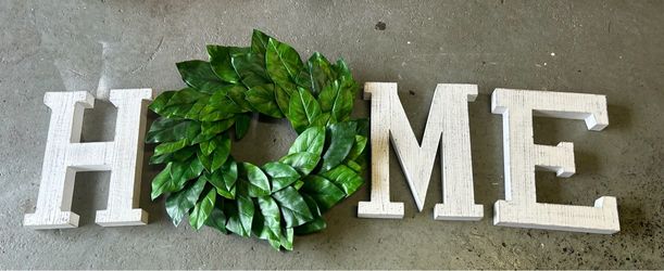 "Home" wooden sign and wreath