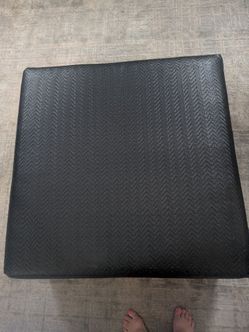 Black leather ottoman
