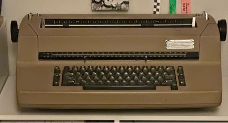 Tan-colored vintage 1970s IBM Selectric II typewriter.