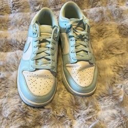 Nike Dunk Low Retro "Glacier Blue" sneakers, featuring a white leather base with icy blue overlays.  