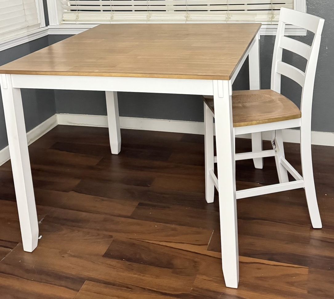 Breakfast bar with table and four high benches.