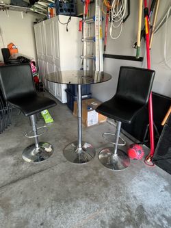 Adjustable Bar table and two leather-like chairs