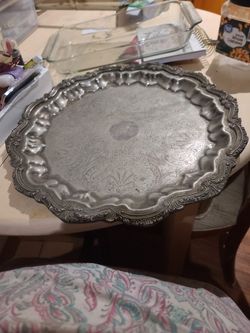 PEWTER ITS VERY HEAVY MISSING 1 OF THREE LEGS BUT BALANCE GOOD ,YOU WONT NOTICE AS IS . FROM THE 1940'S