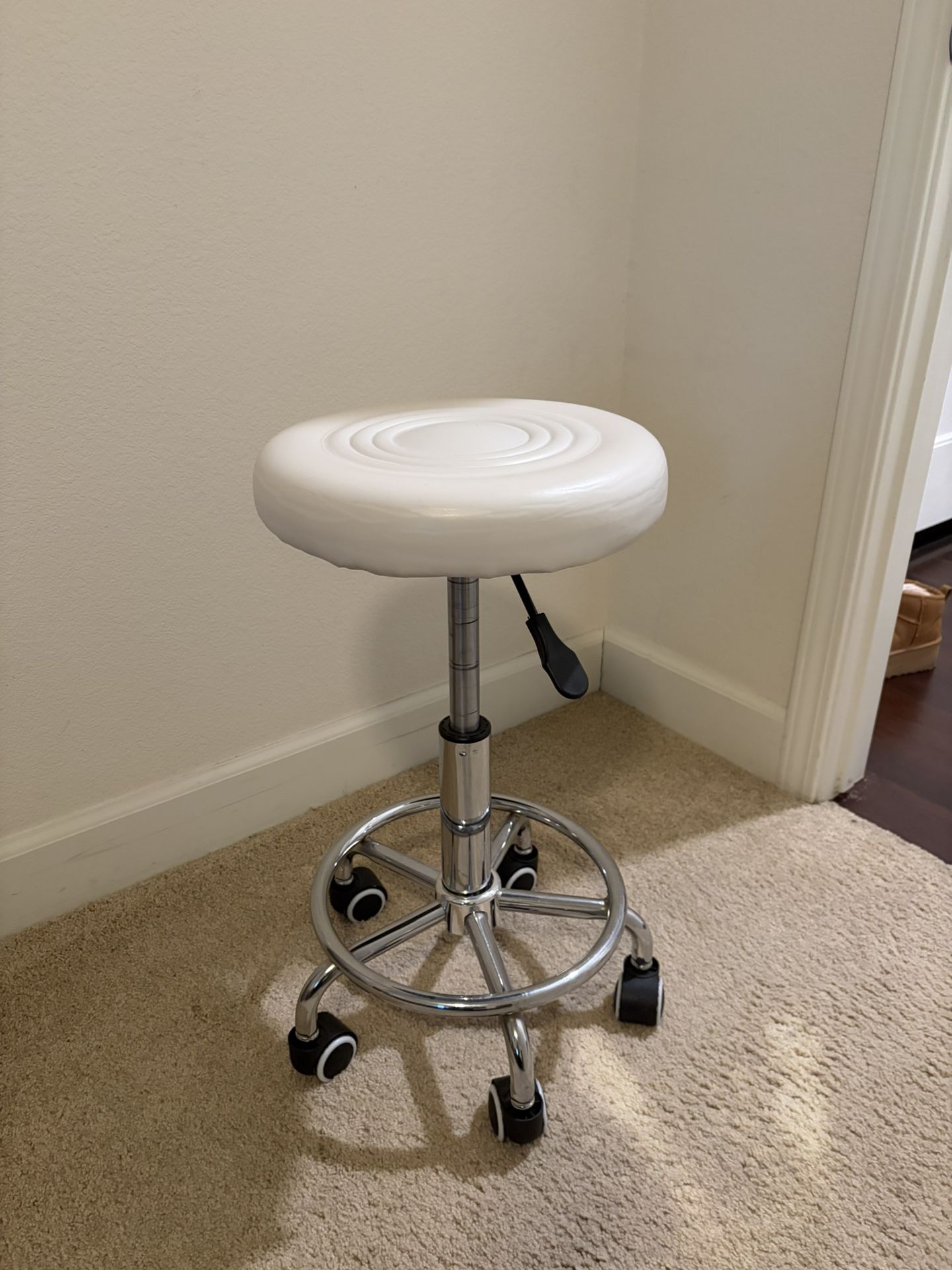 Adjustable white stool with seat cushion