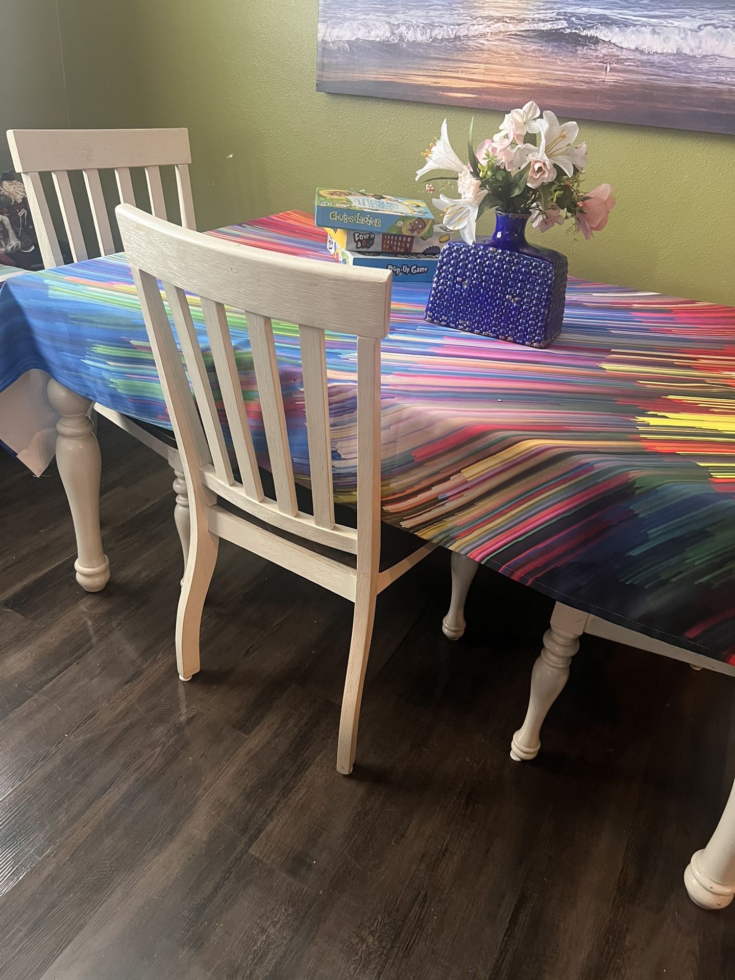 Dining room table with three chairs and a bench
