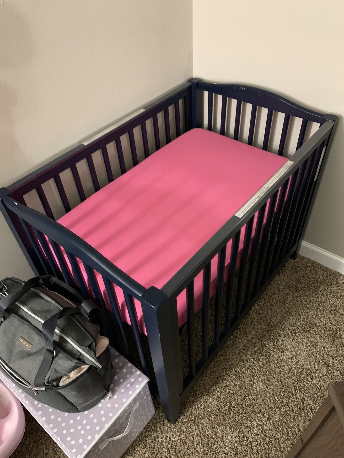 Mini crib and changing table with misc baby stuff