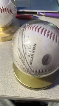 Baseball in case signed by Nolan Ryan. Not sure if signature is real