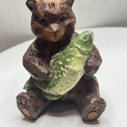 Vintage decoration in the form of a bear with a fish.
