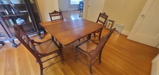 Antique Walnut Dining Room Table with Woven Cane Seated Chairs