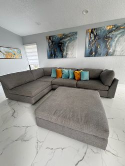 Gray couch and art wall
