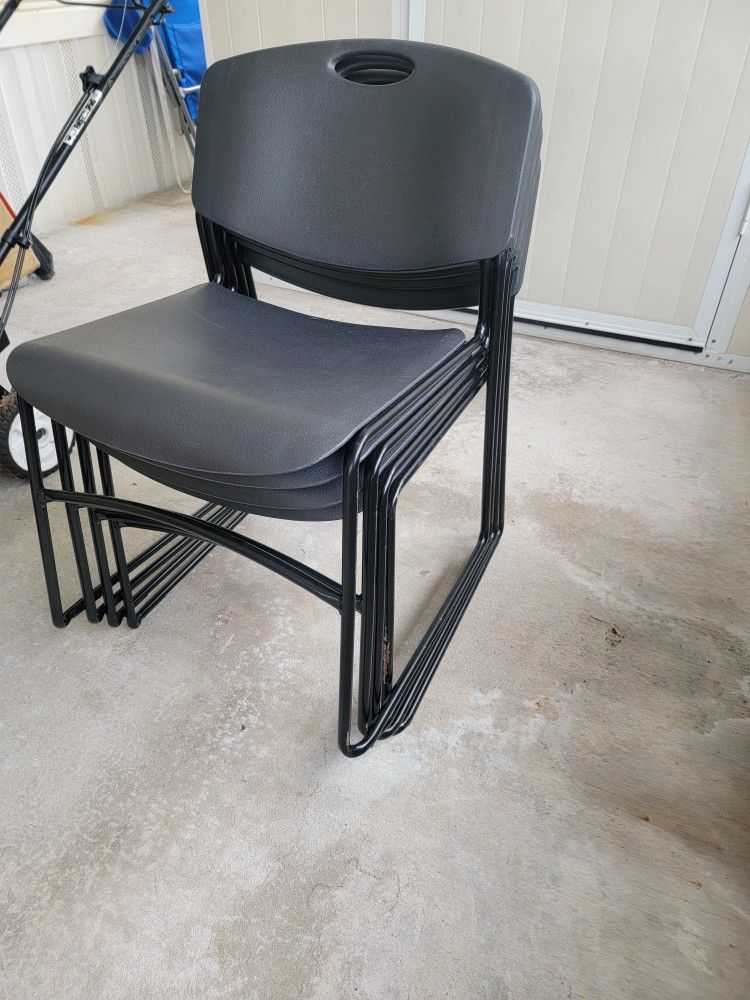 4 Black Plastic Stackable Chairs