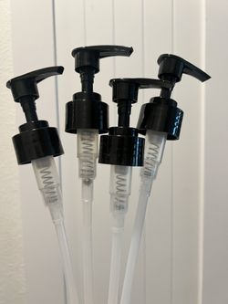 Set of four black pump dispensers