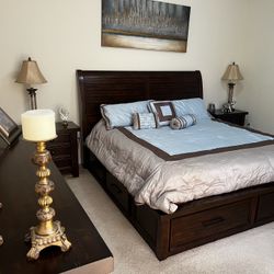 Dark wood Complete Bedroom Set. It Includes A King Size Bed with Two Side Tables, Dresser/Mirror , Entertainment Chest With Drawers, And Tall Dresser 