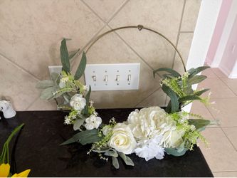 White flower wreath and a bunch of sunflowers