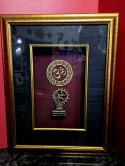 Traditional Indian religious wall hanging featuring two key Hindu symbols: a circular Om motif and a small brass Nataraja (Dancing Shiva) idol. 12"×18