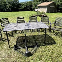 7-piece patio dining set. It is in need of paint and shows some rust due to the lack of paint protection. Brand: Hampton Bay.