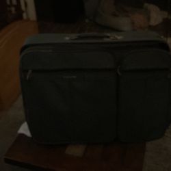 Dark green large suitcase with hidden handle. Sorry they’re so dark pictures.