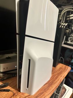 PlayStation 5 with games and a tv