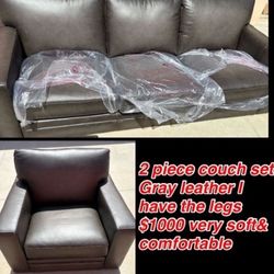 New Couch Set Gray Leather 2 piece includes   1 three seater 1 single seater I have the legs there still wrapped & sealed $1000 OBO cash only 