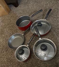 Red Cookware Set Great in condition Includes pots and pans with lids.