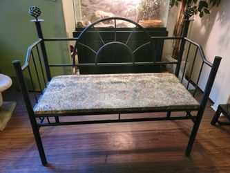 This is a vintage-style wrought iron hall bench featuring a distinctive arches-and-spokes sunburst backrest design and an upholstered tapestry seat.