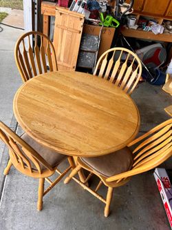 Wooden dining table with four chairs