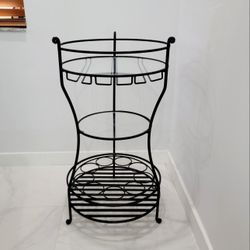Antique and unique round iron wine and glass rack. Ideal for displaying bottles with two glass shelves and three elegant wine glass holders.