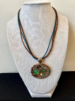Oval Gold Pendant On Boho Cord Necklace