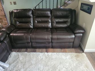 Sofa and love seat. Dark brown with a black ottoman.