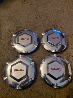 02 envoy new engine  belt  and 2 sets of. Center wheel covers