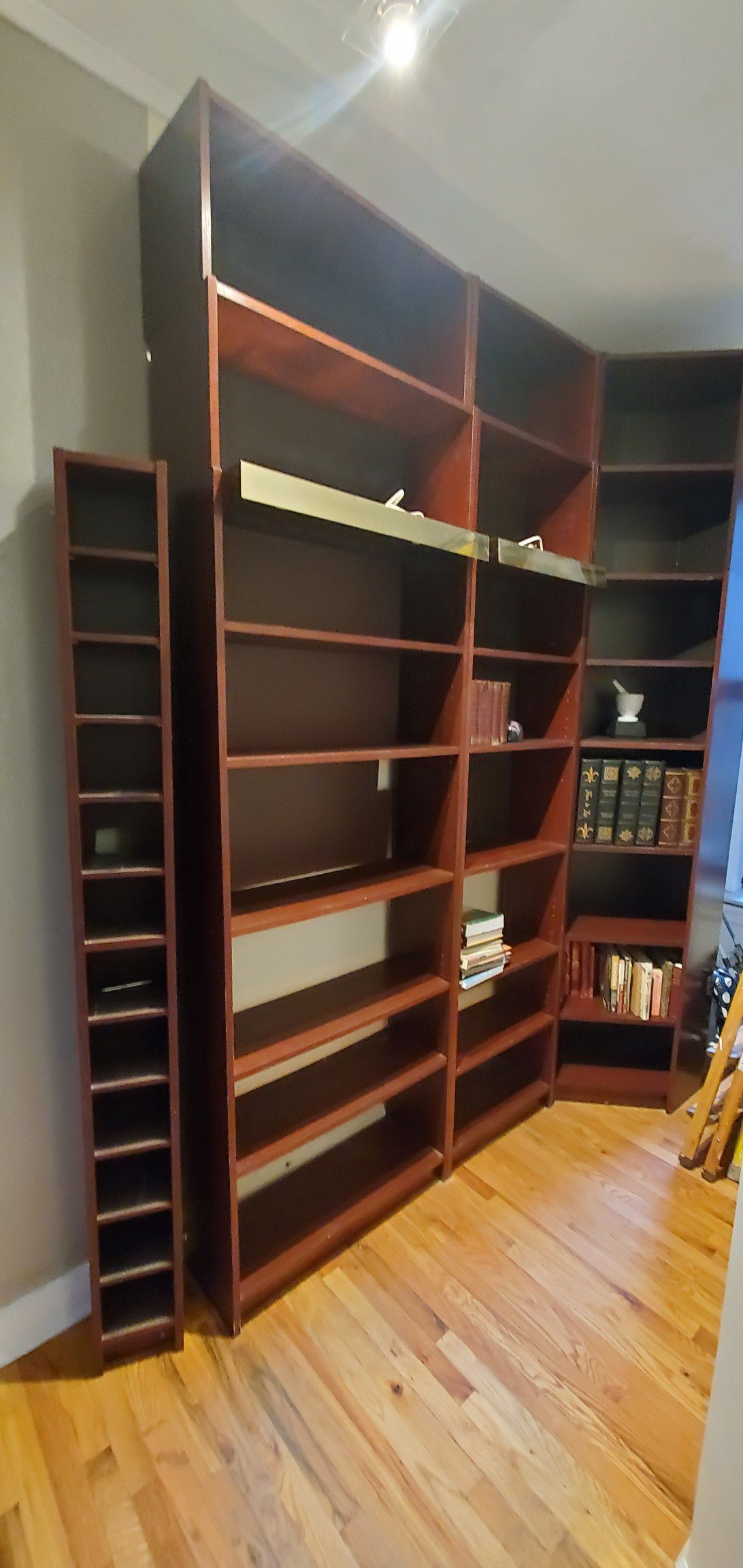 3 Ikea shelves 8 feet tall with 2 feet extensions on top for each shelf