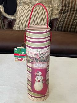 Cylindrical cardboard holiday wine bottle Christmas gift box with a snowman motif. 13” Tall