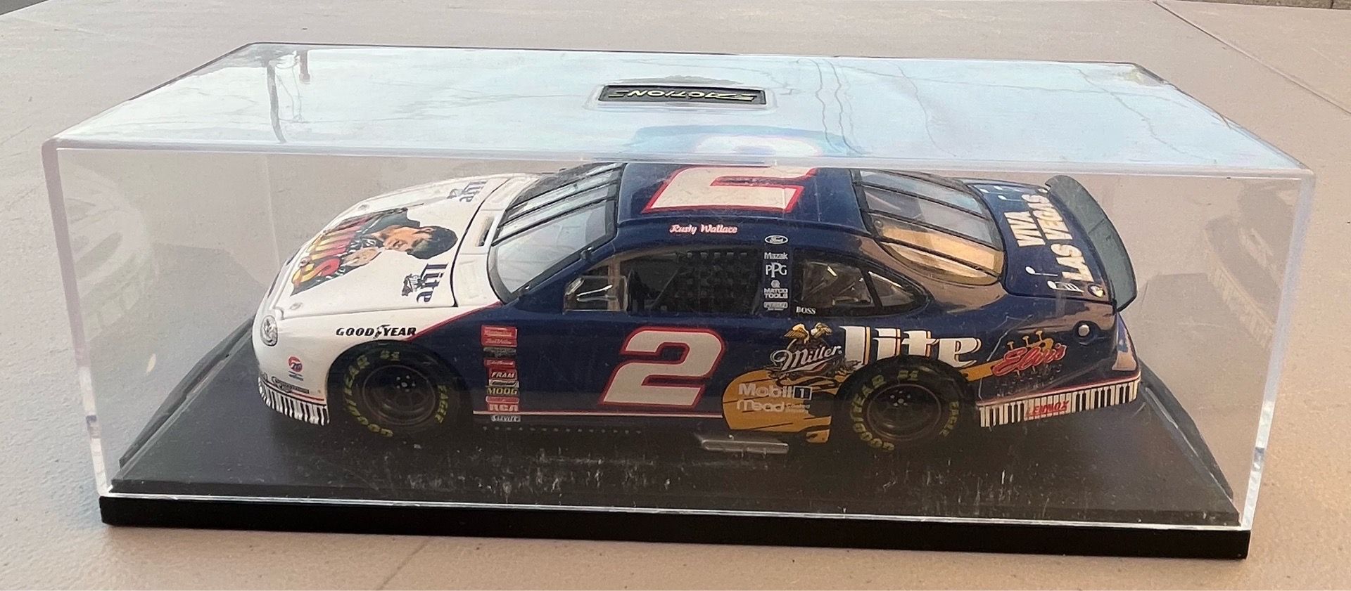24 scale diecast model of the 1998 Ford Taurus NASCAR stock car driven by Rusty Wallace. It features a special Elvis Presley / Miller Lite tribute