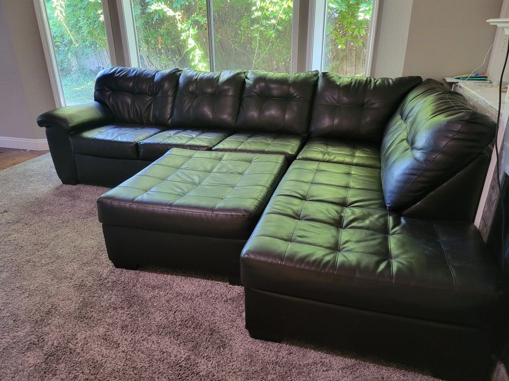 Black Sectional And Ottoman 