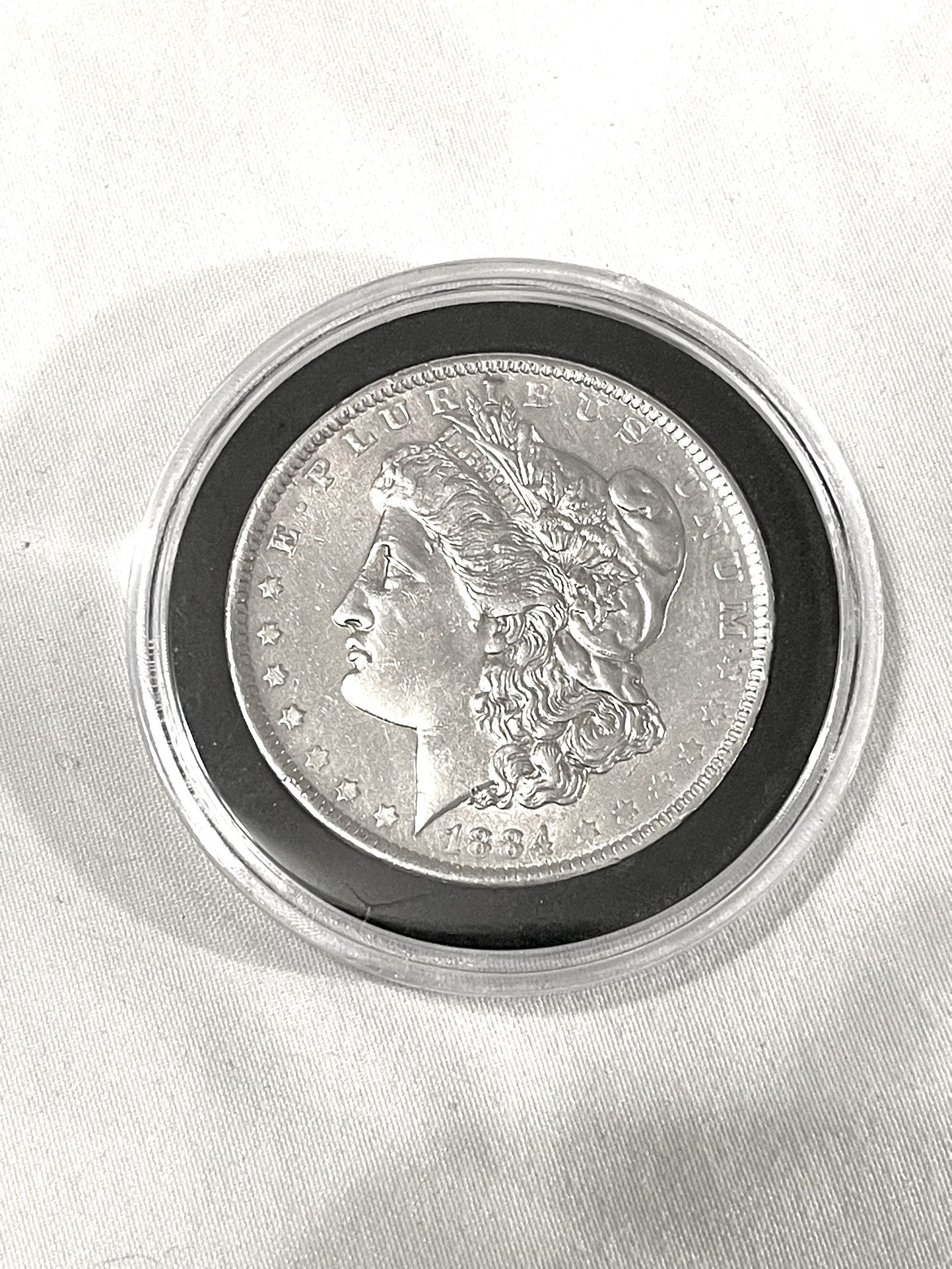 About Uncirculated-AU(50) 1884-O Morgan Silver Dollar. Valued $86 on US Coin book.