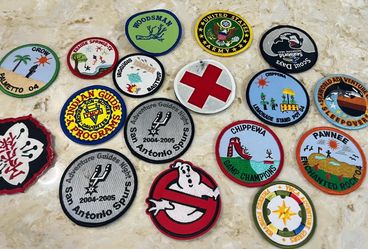Collection of 17 embroidered merit & event patches, primarily from Texas-based scouting, camping, & adventure programs like Indian Guides, YMCA Advent