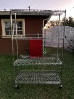 Shelf with casters and wire ledge