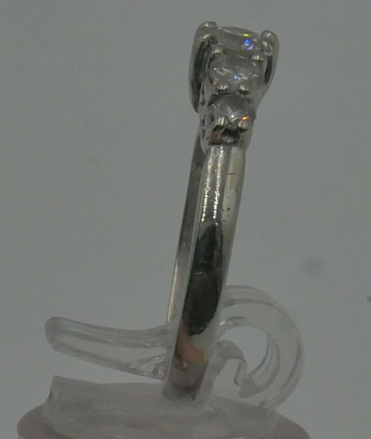 14KT WHITE GOLD ANNIVERSARY BAND SIZE 7.5 3.8 GRAMS WITH 5 DIAMONDS APPROXIMATE CENTER ROUND DIAMOND 0.30 0.35PTS SI2 H; 2 SIDE DIAMONDS 0.16 0.18