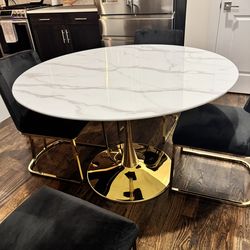 Marble Like Table With Four Black Chairs