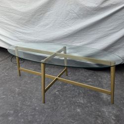 Glass coffee table oval metal base in gold 