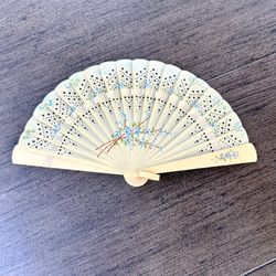 Antique vintage hand-folding celluloid fan with blue flowers