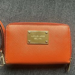 Michael Kors Jet Set orange saffiano leather wallet.