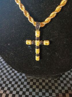 Silver Cross 925 Silver that's gold-plated with yellow and black white diamonds weighs 7.1 g of silver on a 14 karat gold plated rope chain heavy duty